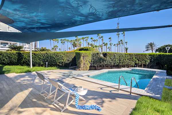 Beautiful lady relaxes by the pool of the Garden Suite